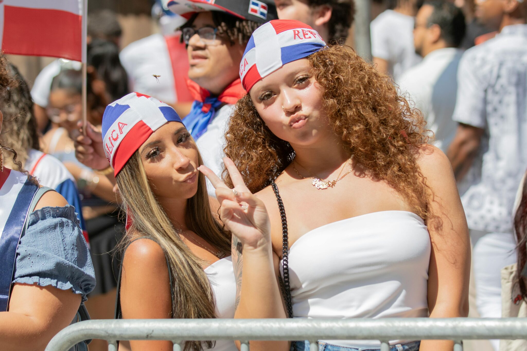 Vibrant street parade in New York showcasing Dominican pride with colorful outfits and lively atmosphere.